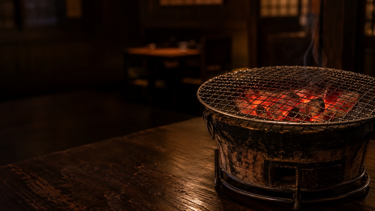 七輪の中で赤く熾る備長炭と焼き網